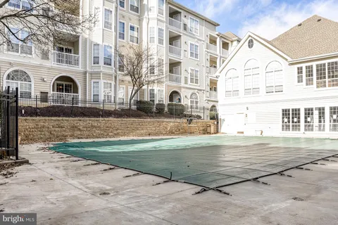 a view of a swimming pool with outdoor seating and plants