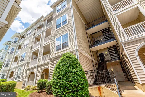 a front view of a residential apartment building with a yard