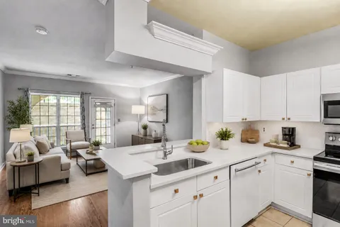 a kitchen with stainless steel appliances white cabinets and a stove top oven