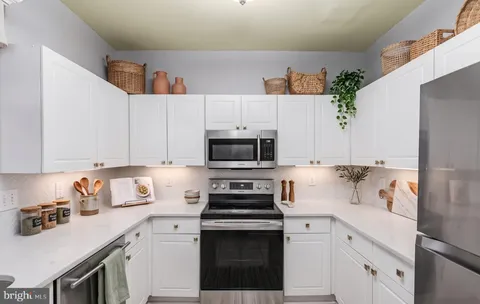 a kitchen with stainless steel appliances a refrigerator sink and microwave