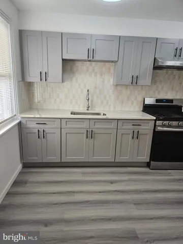 a kitchen with wooden cabinets and a sink