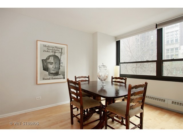 33 East Cedar Street, Unit 5F Chicago, IL 60611 - Photo 4 of 11 a view of a dining room with furniture and window