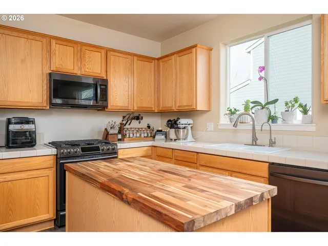 a kitchen with a stove a sink and a microwave