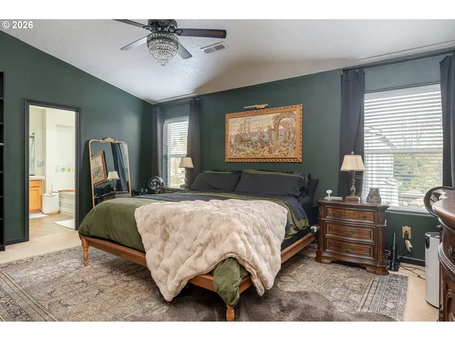 a bed room with a bed mirror and a window