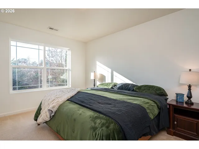 a bedroom with a bed a table and chair