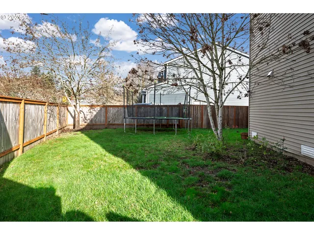 a view of a house with a yard and sitting area