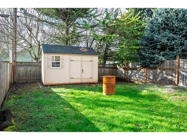 a backyard of a house with table and chairs