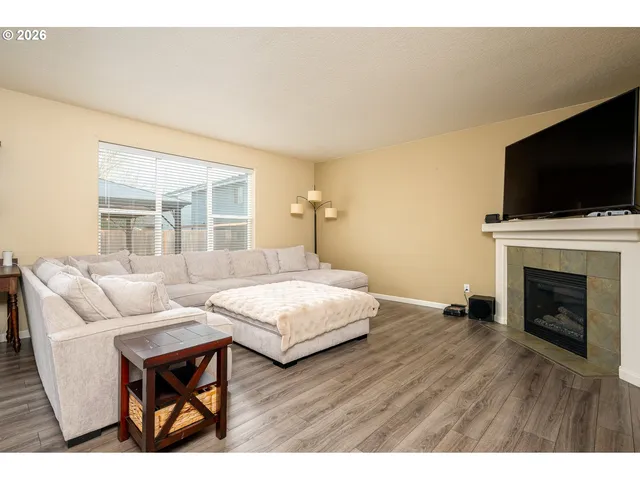 a living room with furniture fireplace and flat screen tv