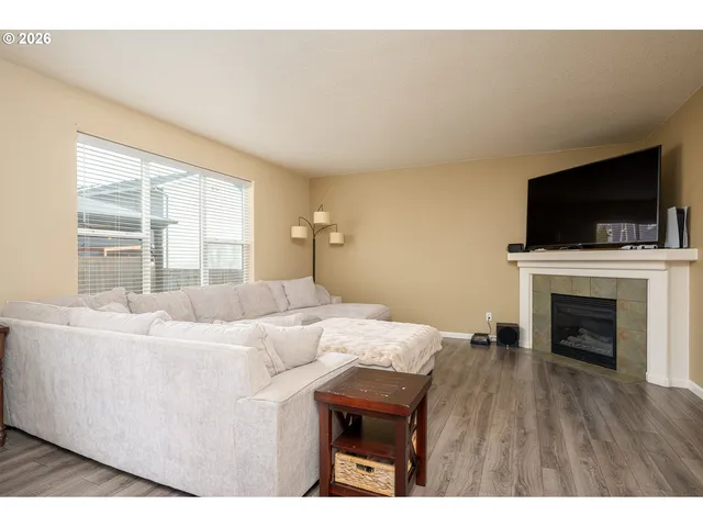 a living room with a flat screen tv and a fireplace