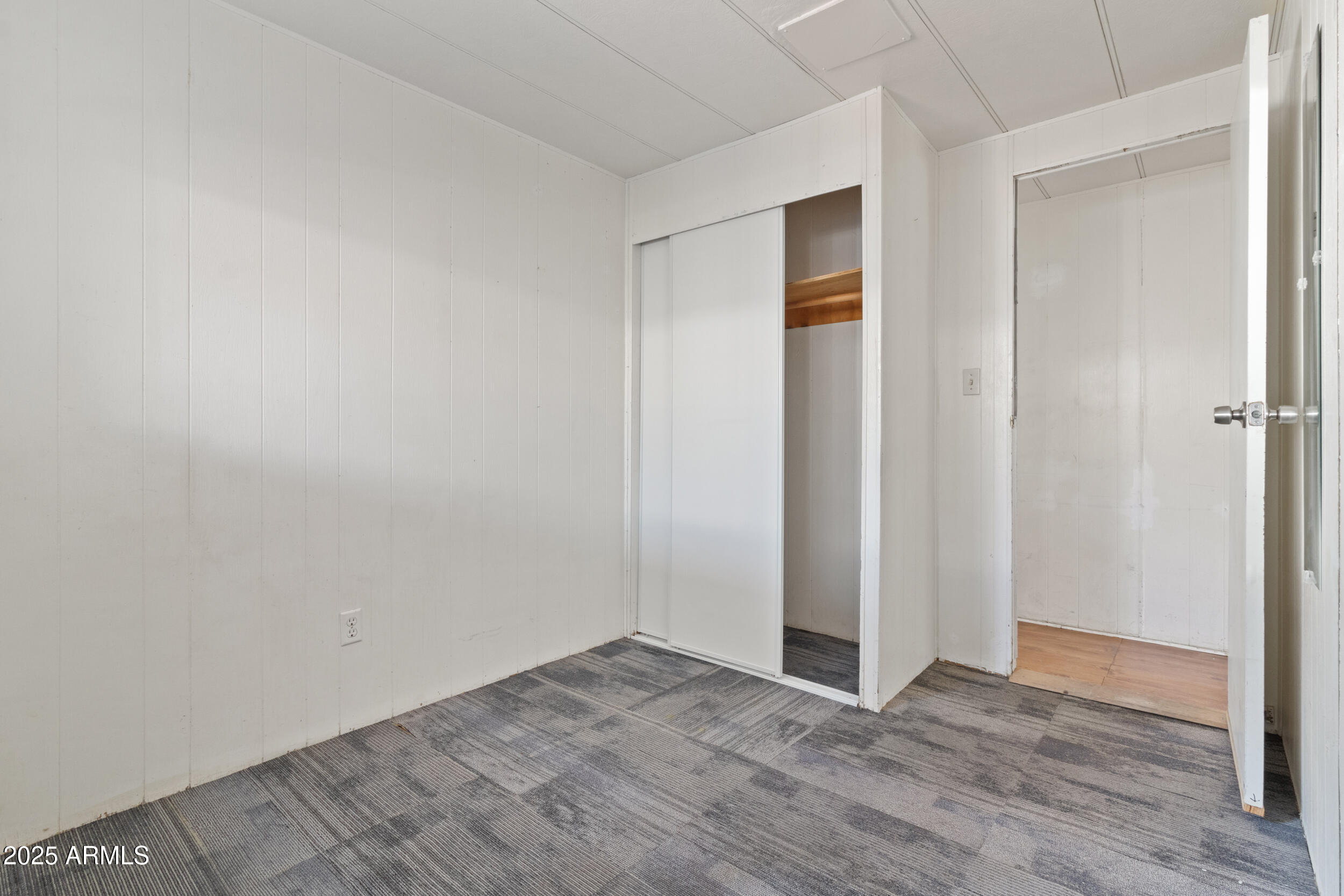 535 South Alma School Road, Unit 12 Mesa, AZ 85210 - Photo 13 of 66 a view of an empty room with wooden floor and closet
