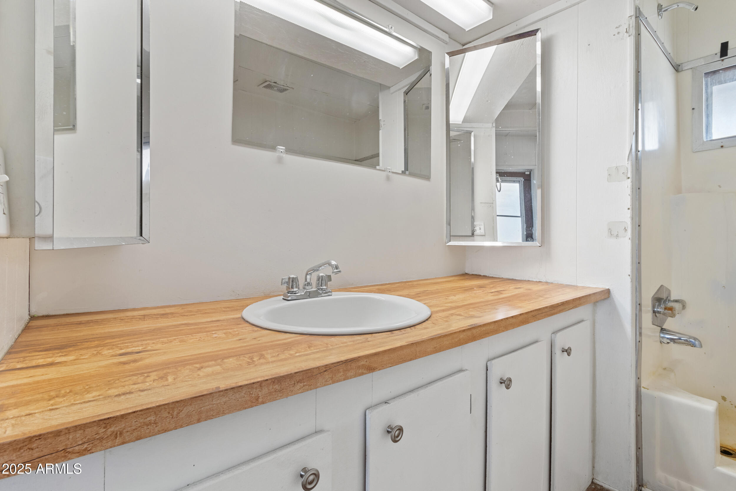 535 South Alma School Road, Unit 12 Mesa, AZ 85210 - Photo 14 of 66 a bathroom with a granite countertop sink and a mirror