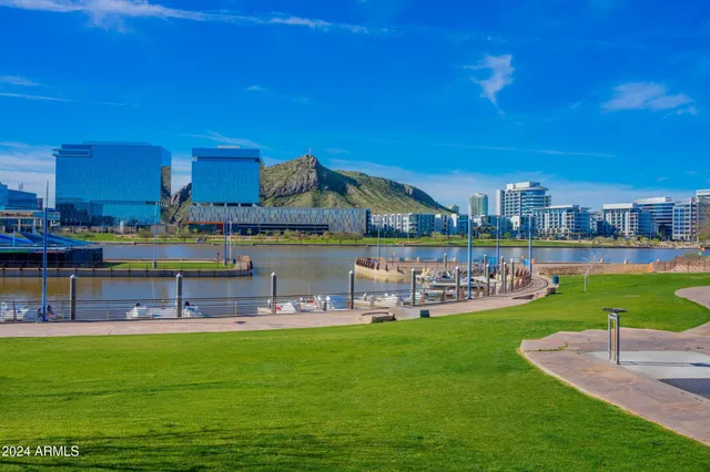 a kitchen with stainless steel appliances granite countertop a sink counter space cabinets and a stove