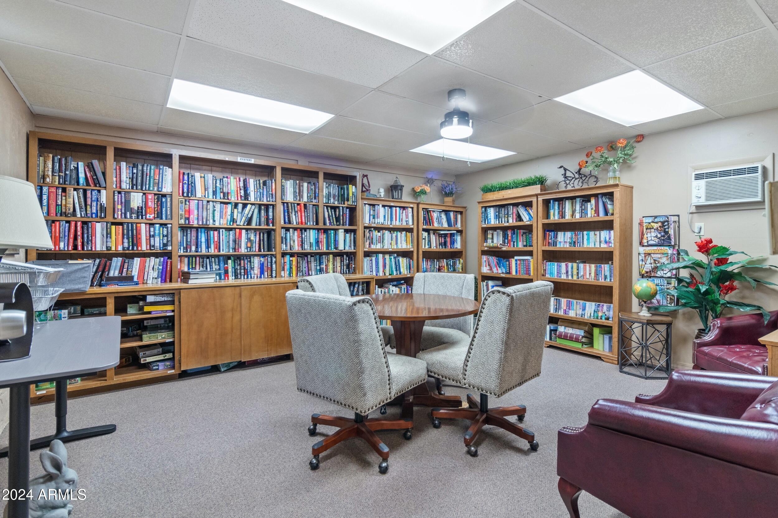 535 South Alma School Road, Unit 12 Mesa, AZ 85210 - Photo 43 of 66 a view of a workspace with furniture and a bookshelf