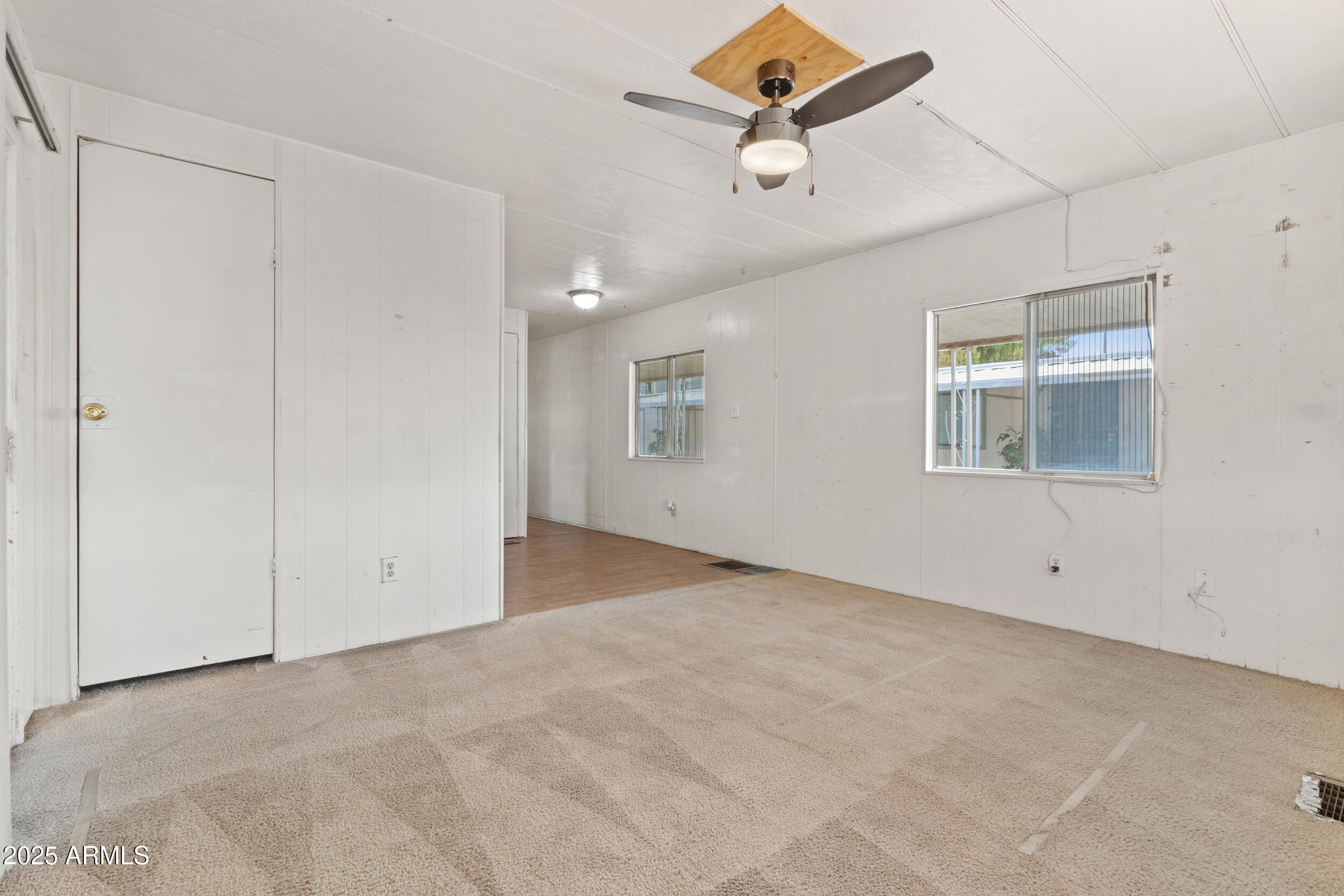 535 South Alma School Road, Unit 12 Mesa, AZ 85210 - Photo 7 of 66 an empty room with windows and ceiling fan
