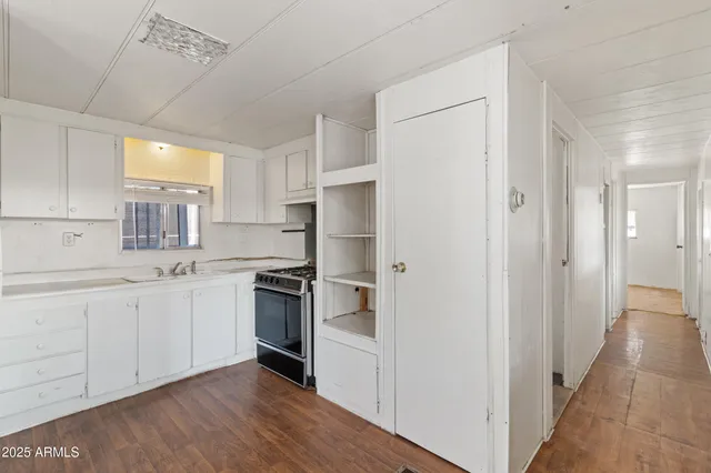 a kitchen with granite countertop a stove and a refrigerator