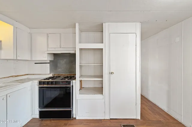 a kitchen with white cabinets and white appliances