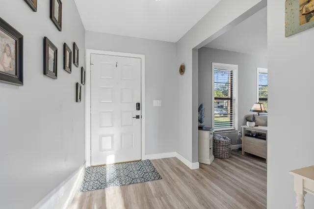a living room with furniture a flat screen tv and a rug