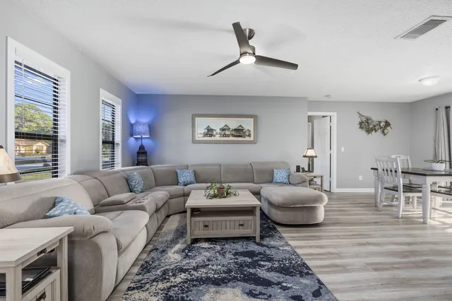 a view of a dining room with furniture and wooden floor