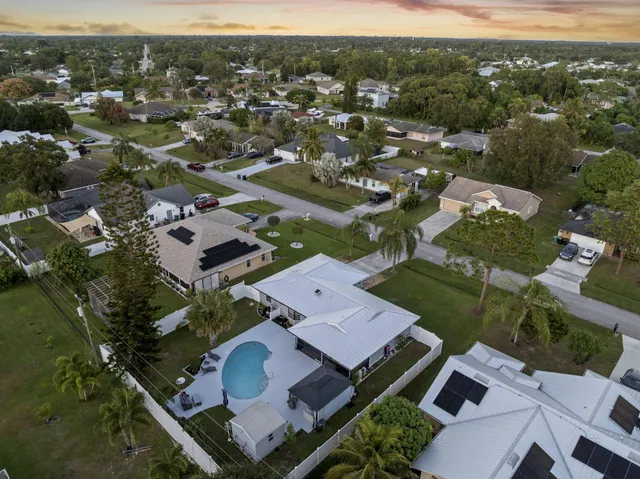 an aerial view of a house with a mountain