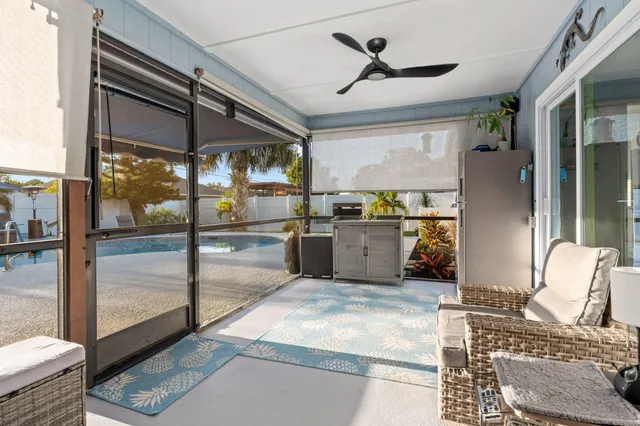 a view of a patio with a table and chairs and potted plants