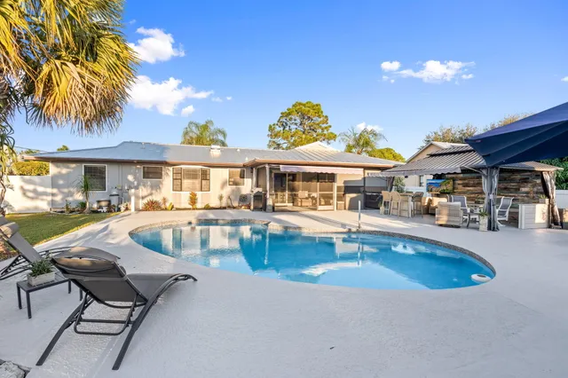 a view of a patio with swimming pool table and chairs