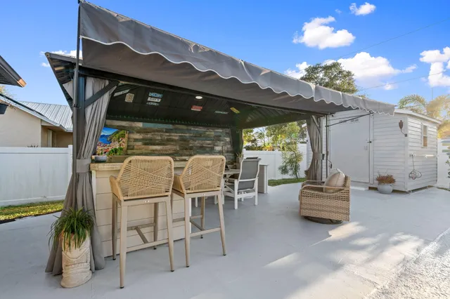 a view of a swimming pool with outdoor seating