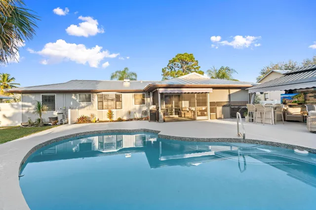 a view of house with outdoor space and swimming pool