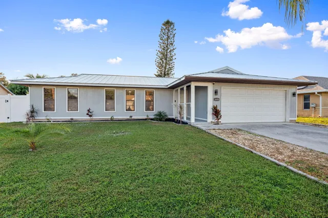 a front view of house with yard and outdoor seating