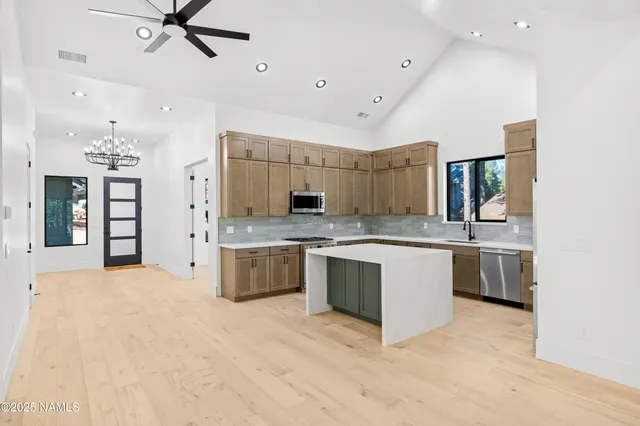 a utility room with wooden floor washer and dryer