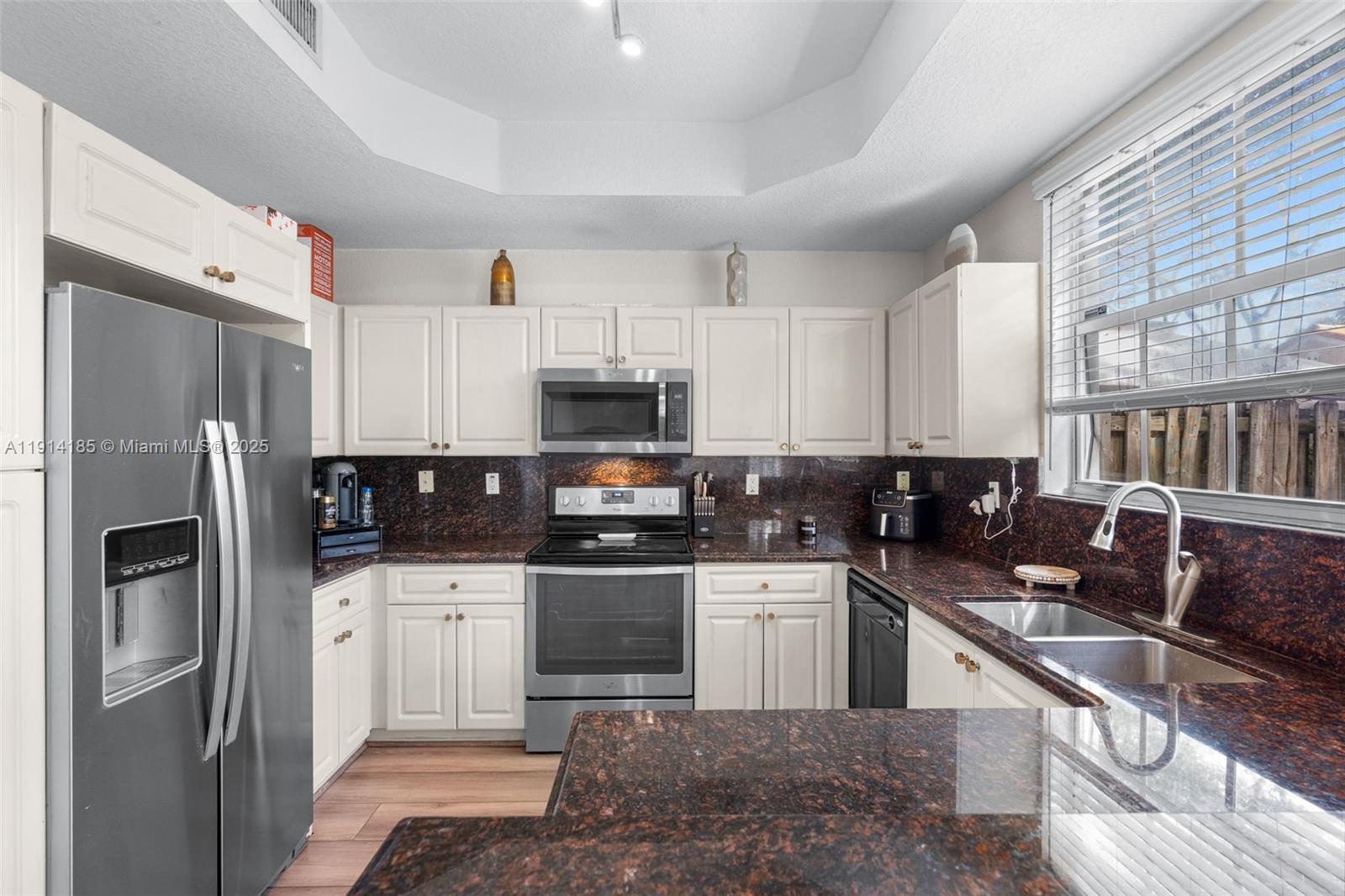 8181 Southwest 118th Court Miami, FL 33183 - Photo 14 of 33 a kitchen with stainless steel appliances a refrigerator sink and cabinets