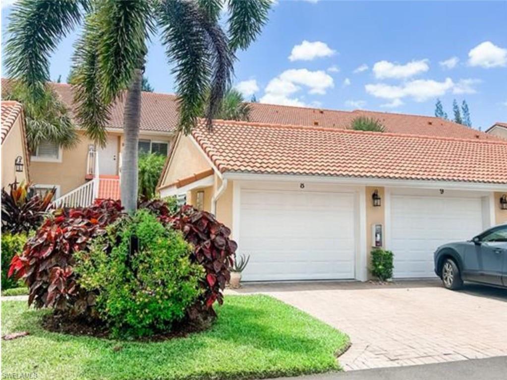 2380 Bayou Lane, Unit 7709 Naples, FL 34112 - Photo 14 of 15 View of front of home featuring an attached garage, stucco siding, and a tile roof