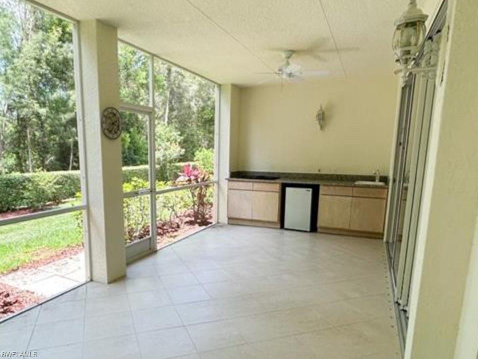 2380 Bayou Lane, Unit 7709 Naples, FL 34112 - Photo 9 of 15 Unfurnished sunroom with a sink, ceiling fan, and plenty of natural light