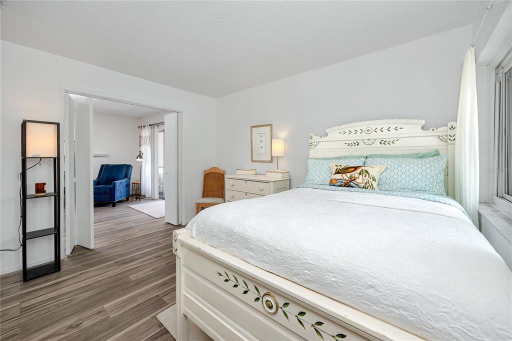 2207 Belleair Road, Unit B30 Clearwater, FL 33764 - Photo 25 of 39 a bedroom with a bed and wooden floor