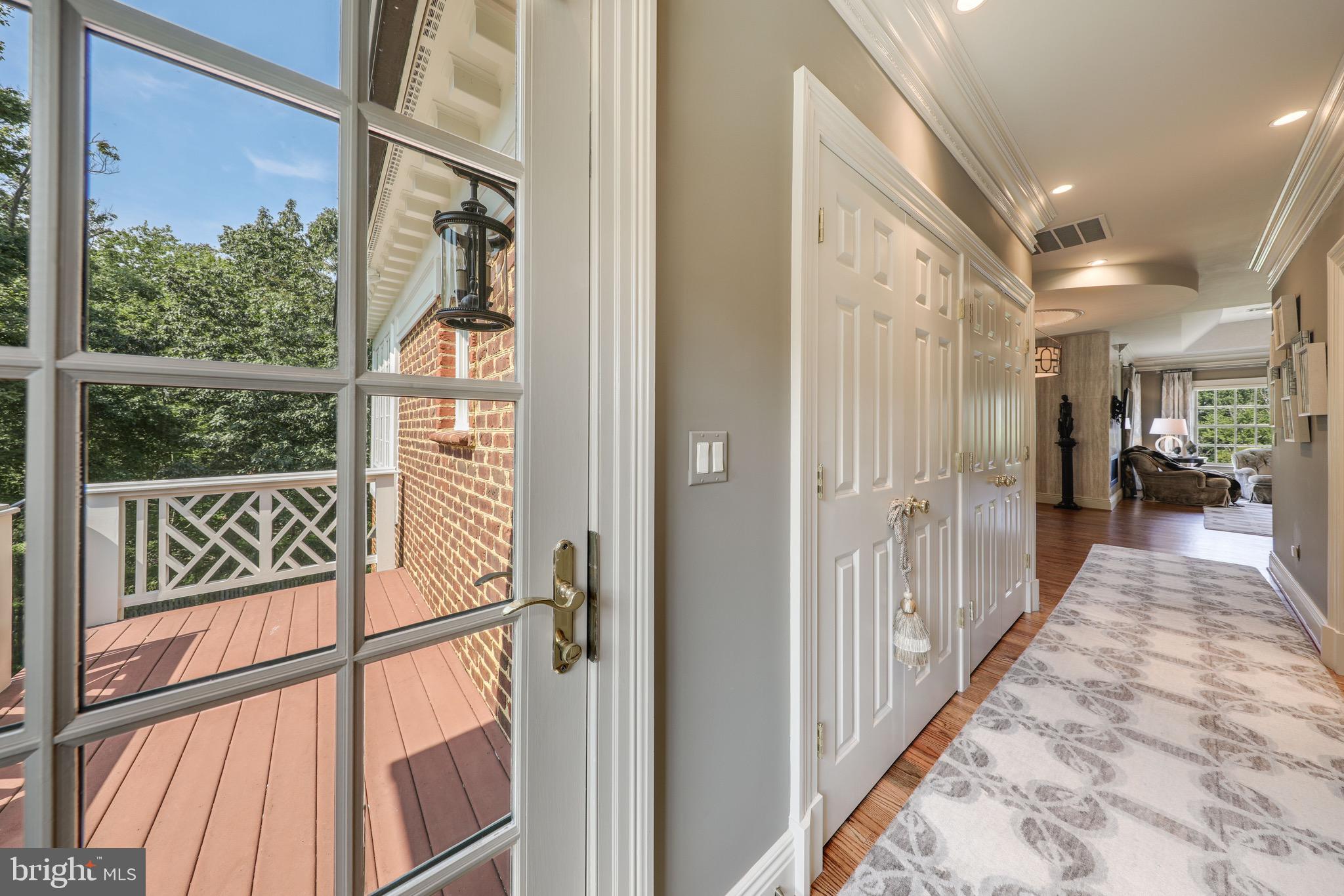 11720 Centurion Way Potomac, MD 20854 - Photo 41 of 81 a view of a hallway with wooden floor and staircase