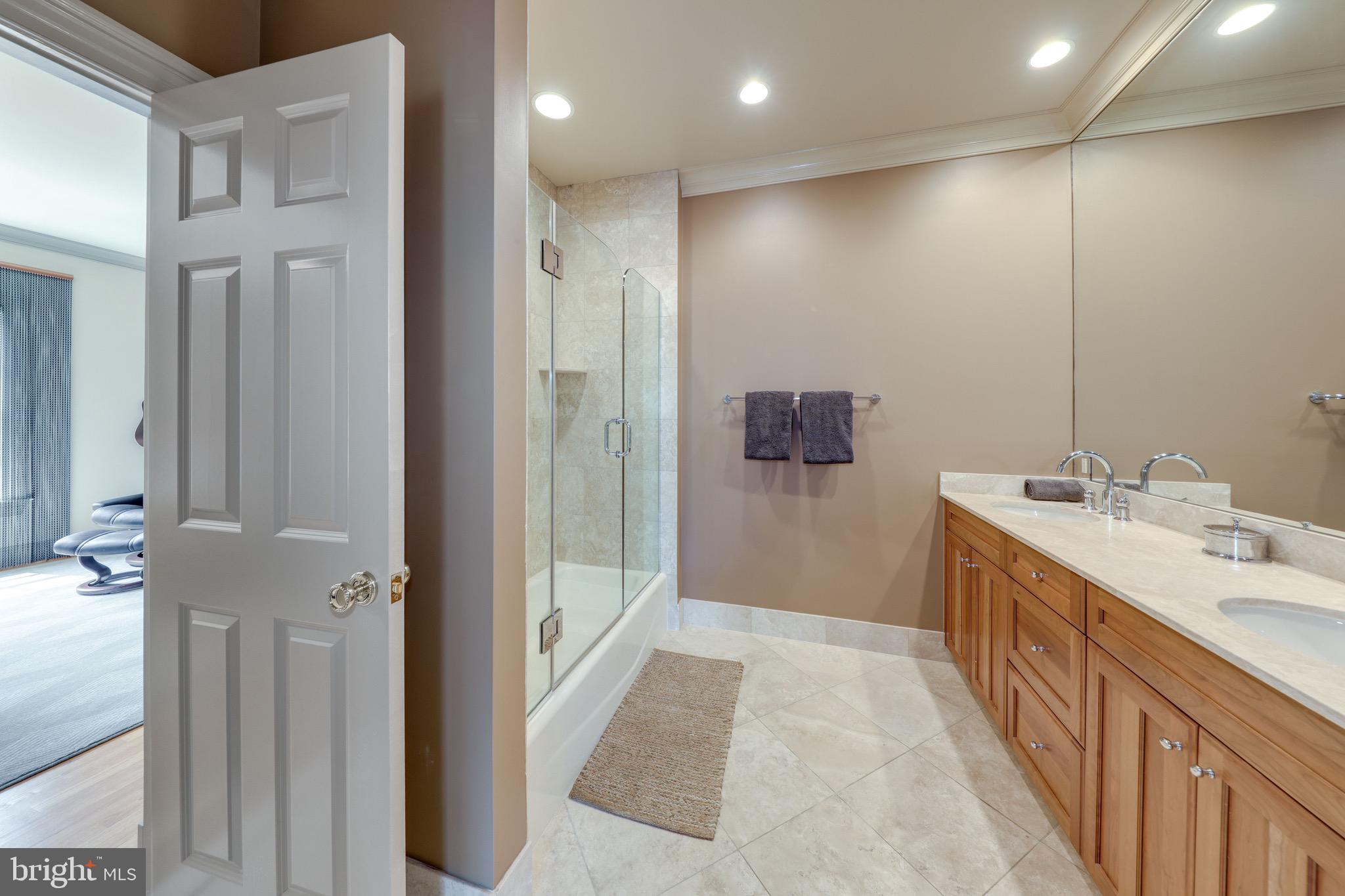 11720 Centurion Way Potomac, MD 20854 - Photo 46 of 81 a bathroom with a double vanity sink a toilet and shower