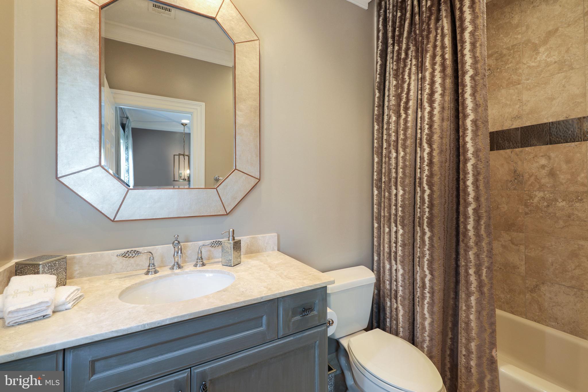 11720 Centurion Way Potomac, MD 20854 - Photo 48 of 81 a bathroom with a granite countertop sink toilet and shower