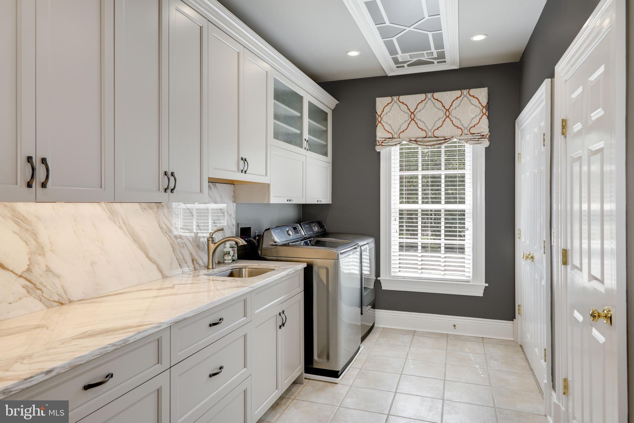 11720 Centurion Way Potomac, MD 20854 - Photo 49 of 81 a kitchen with granite countertop a sink stainless steel appliances and cabinets