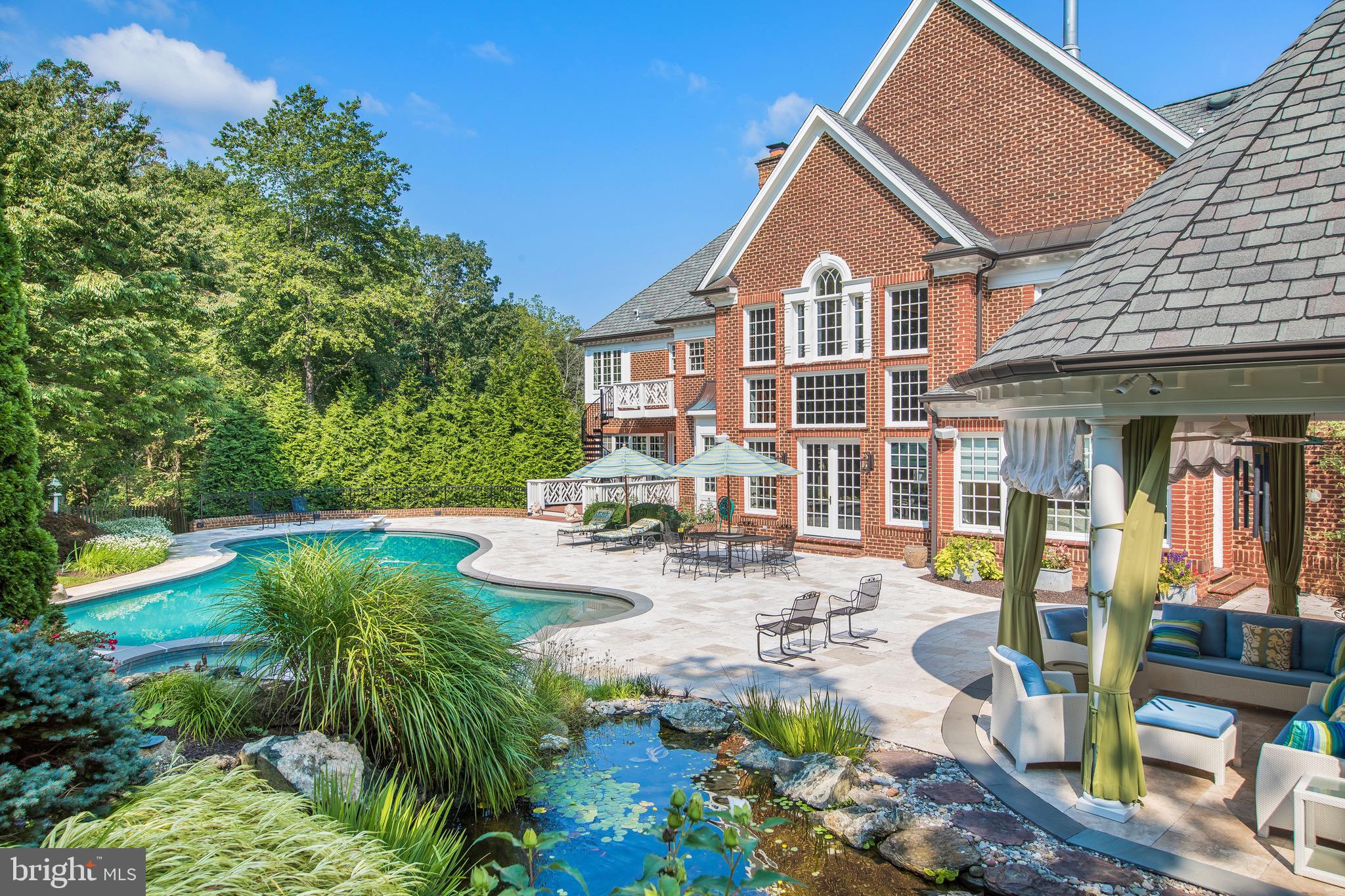 11720 Centurion Way Potomac, MD 20854 - Photo 60 of 81 a front view of a house with garden