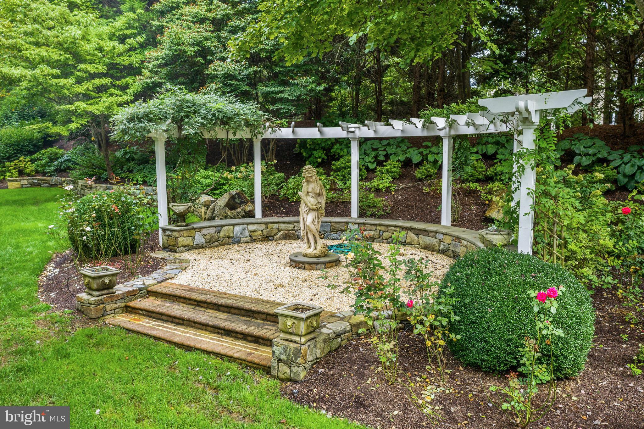 11720 Centurion Way Potomac, MD 20854 - Photo 72 of 81 a view of a backyard with sitting area and garden