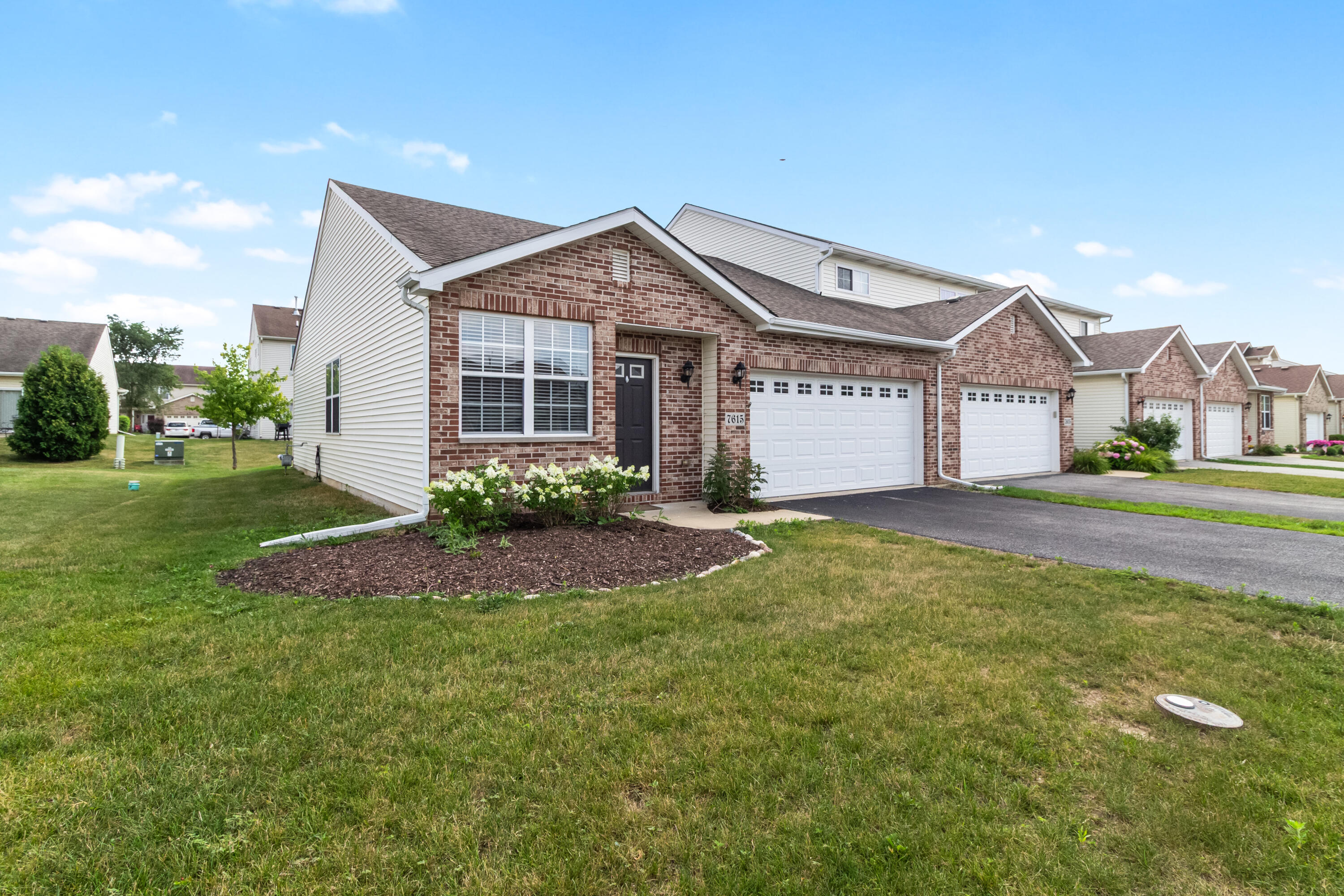 7615 111th Lane Crown Point, IN 46307 - Photo 18 of 19 a view of a house next to a big yard and large trees