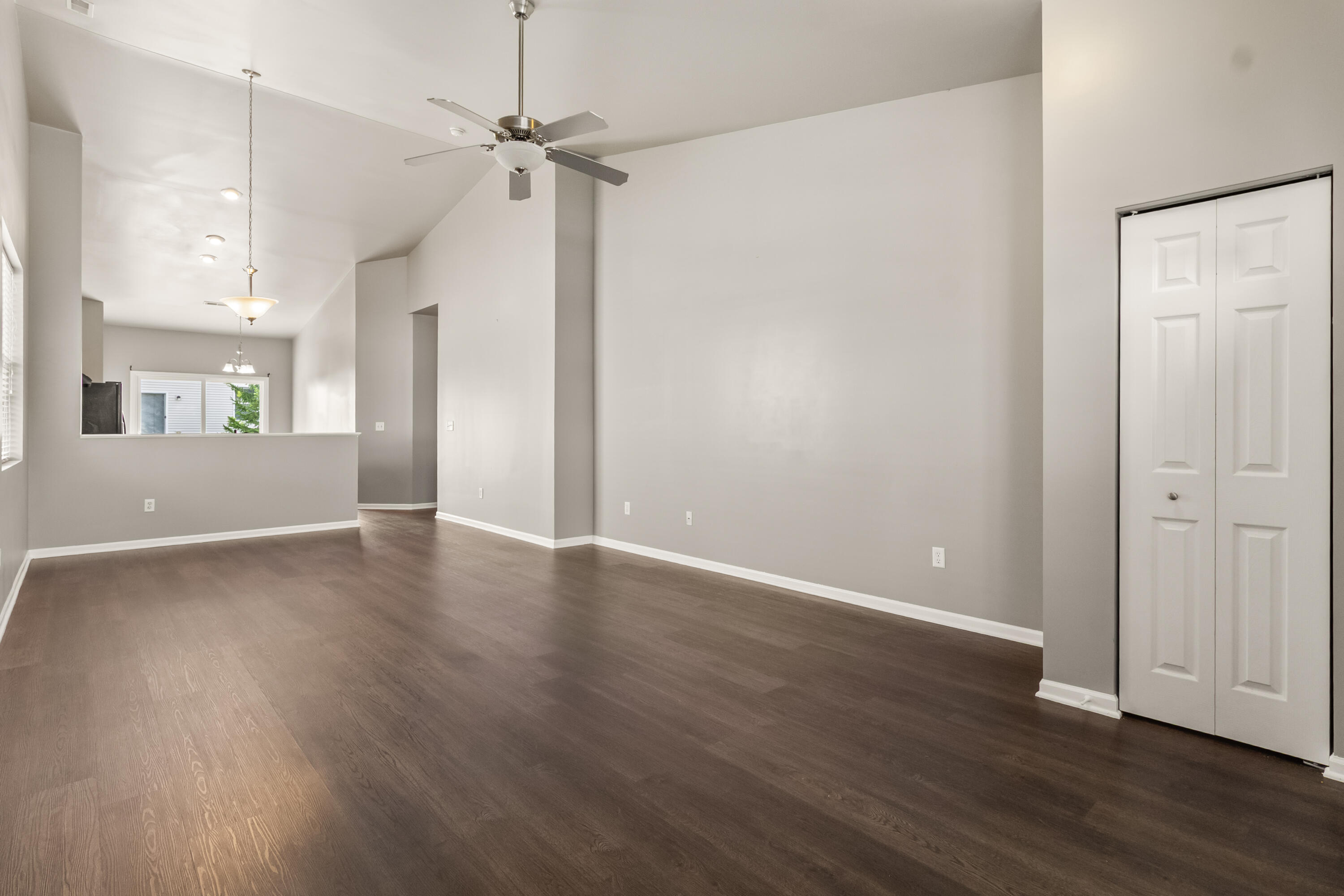 7615 111th Lane Crown Point, IN 46307 - Photo 2 of 19 an empty room with wooden floor a ceiling fan and windows