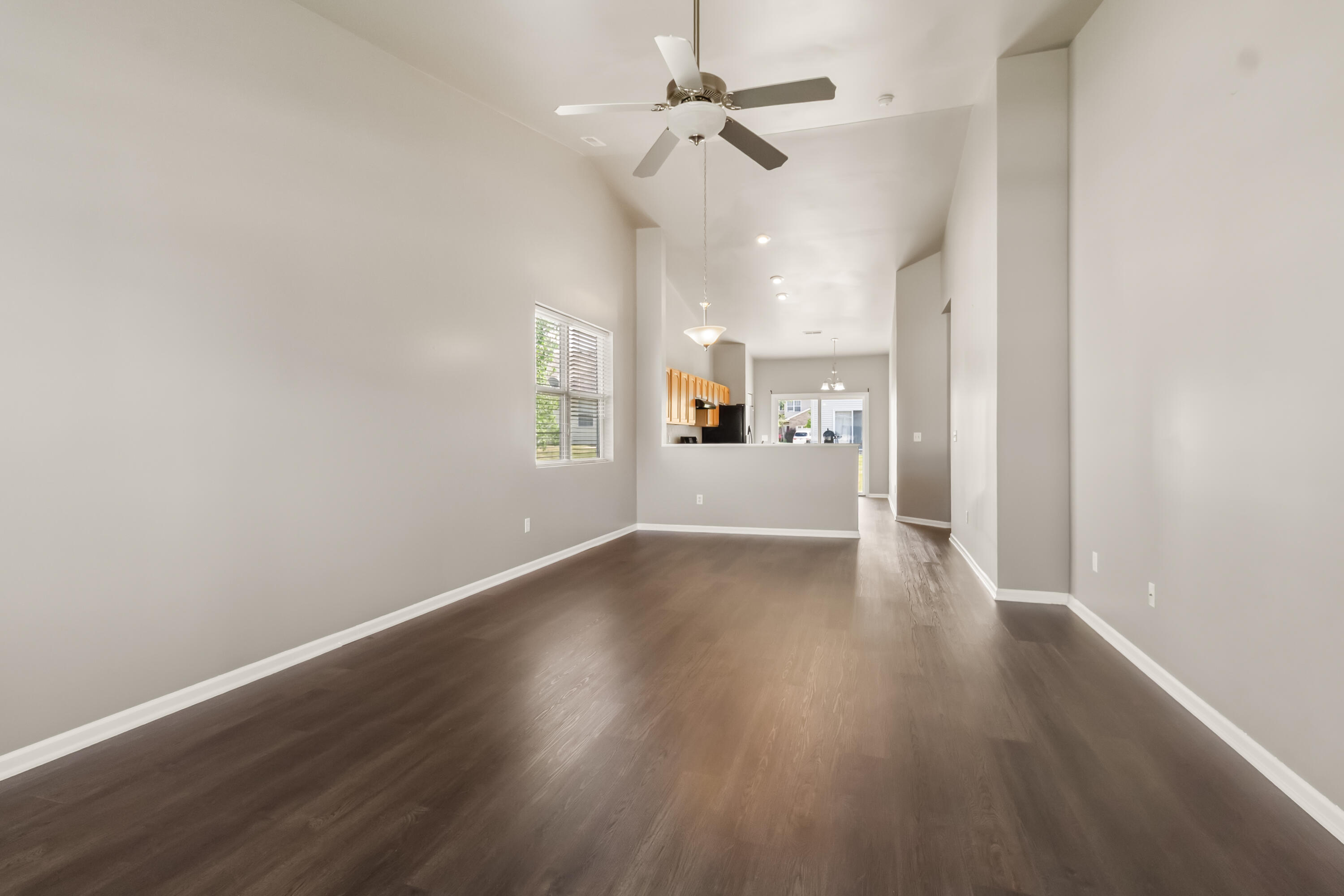 7615 111th Lane Crown Point, IN 46307 - Photo 3 of 19 an empty room with wooden floor ceiling fan and windows