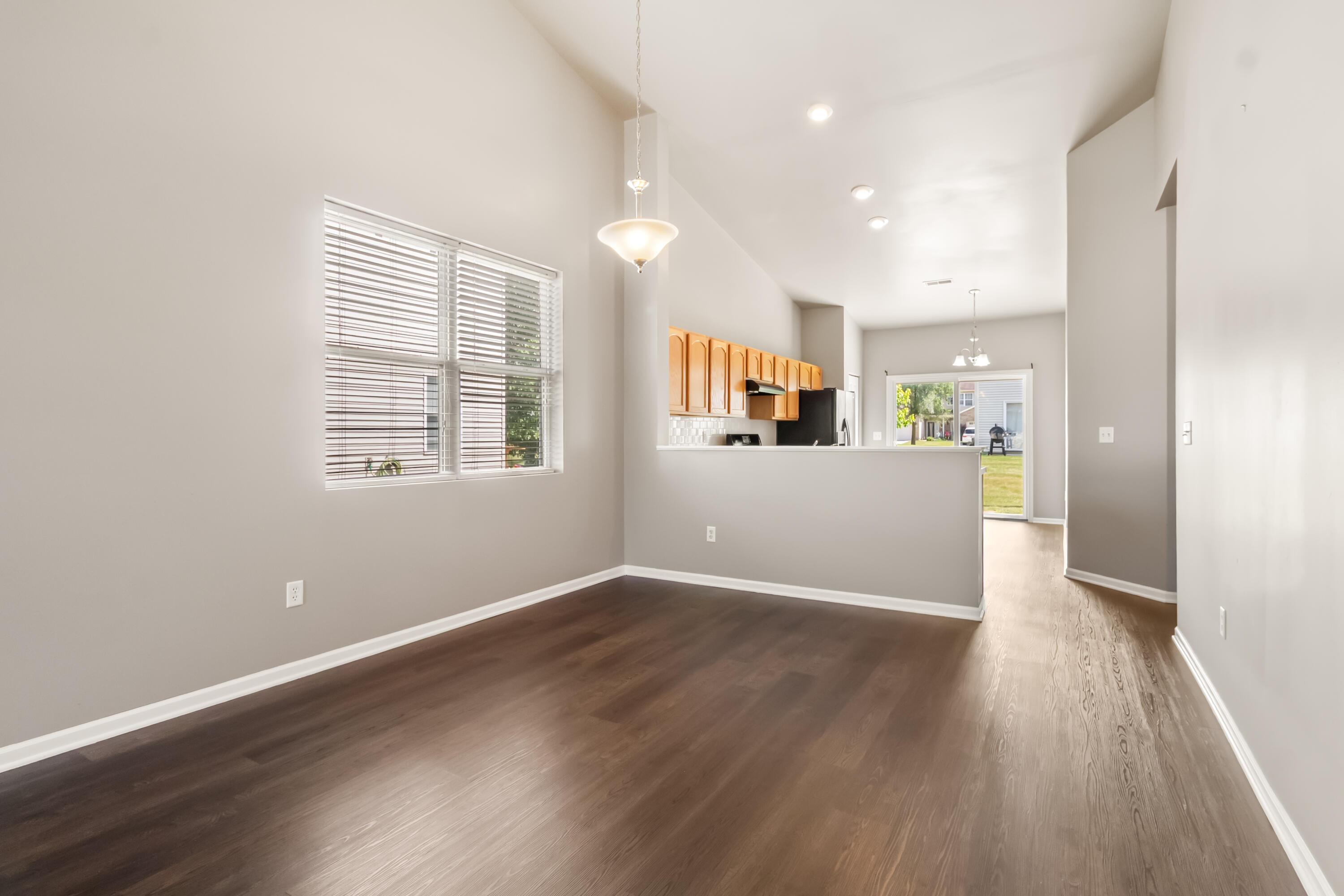 7615 111th Lane Crown Point, IN 46307 - Photo 4 of 19 a view of a kitchen and an empty room with wooden floor
