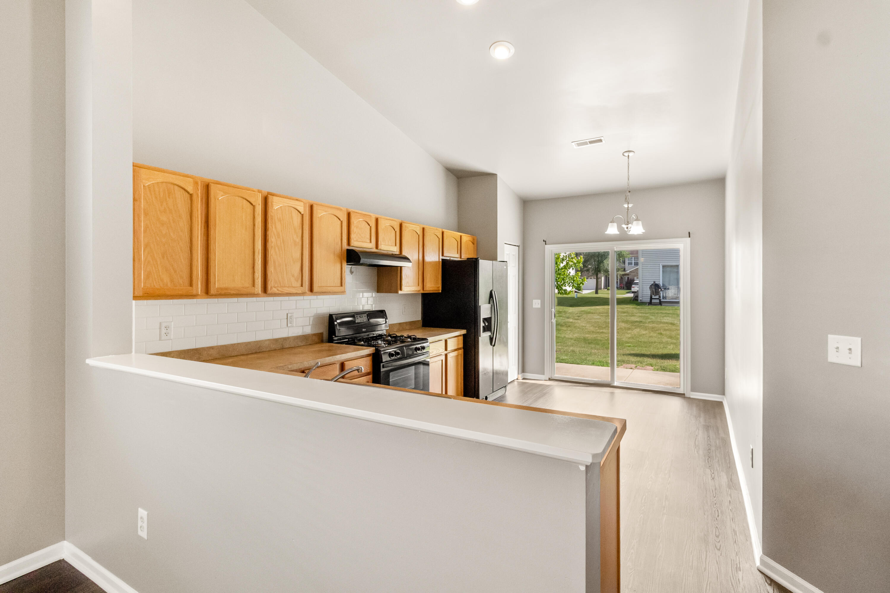 7615 111th Lane Crown Point, IN 46307 - Photo 9 of 19 a view of a kitchen with kitchen island wooden floor and stainless steel appliances