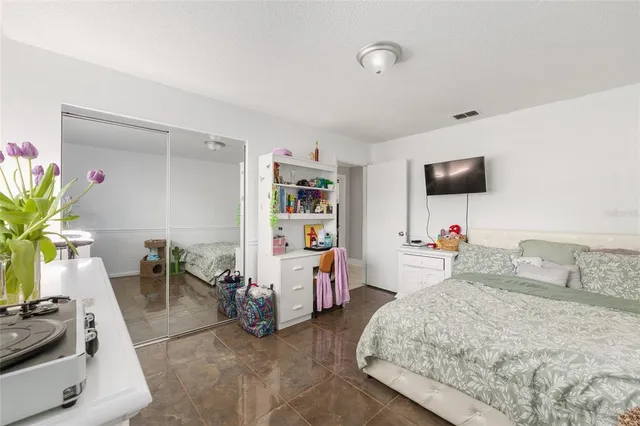 a bedroom with a bed and a chair in it