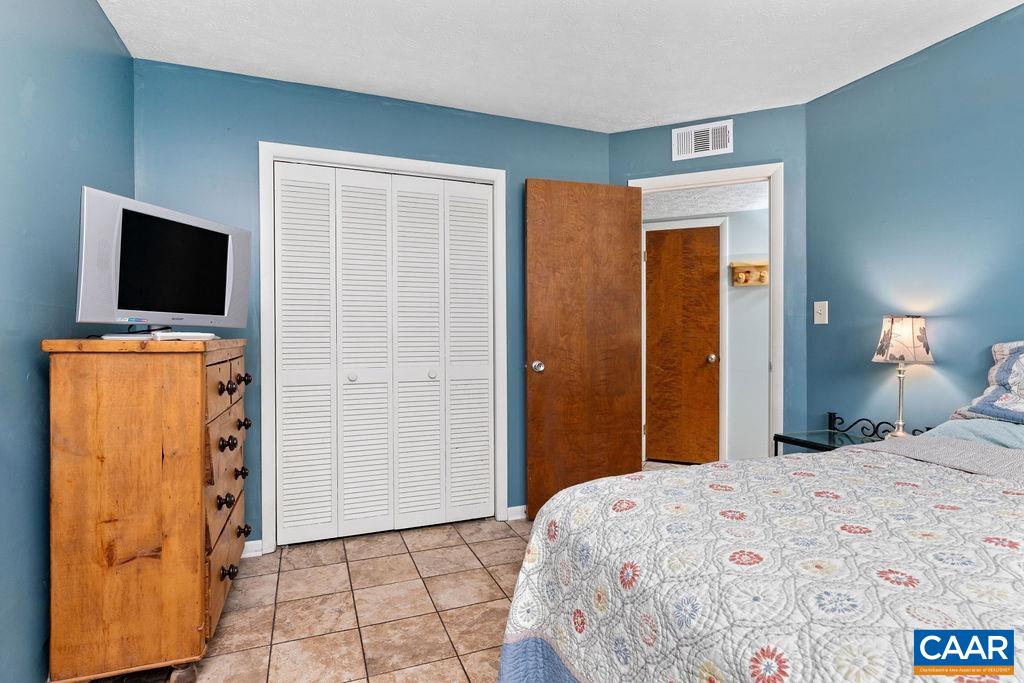 464 3 Ridges Roseland, VA 22967 - Photo 15 of 29 a bedroom with a bed and a flat screen tv