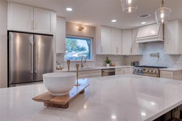 a living room with stainless steel appliances granite countertop furniture a couch and a view of kitchen
