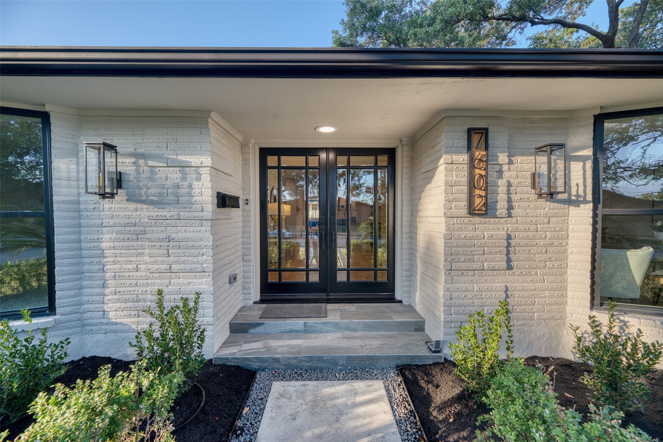 7602 Pagewood Lane Houston, TX 77063 - Photo 5 of 33 Gas lanterns softly illuminate the entry for timeless curb appeal.