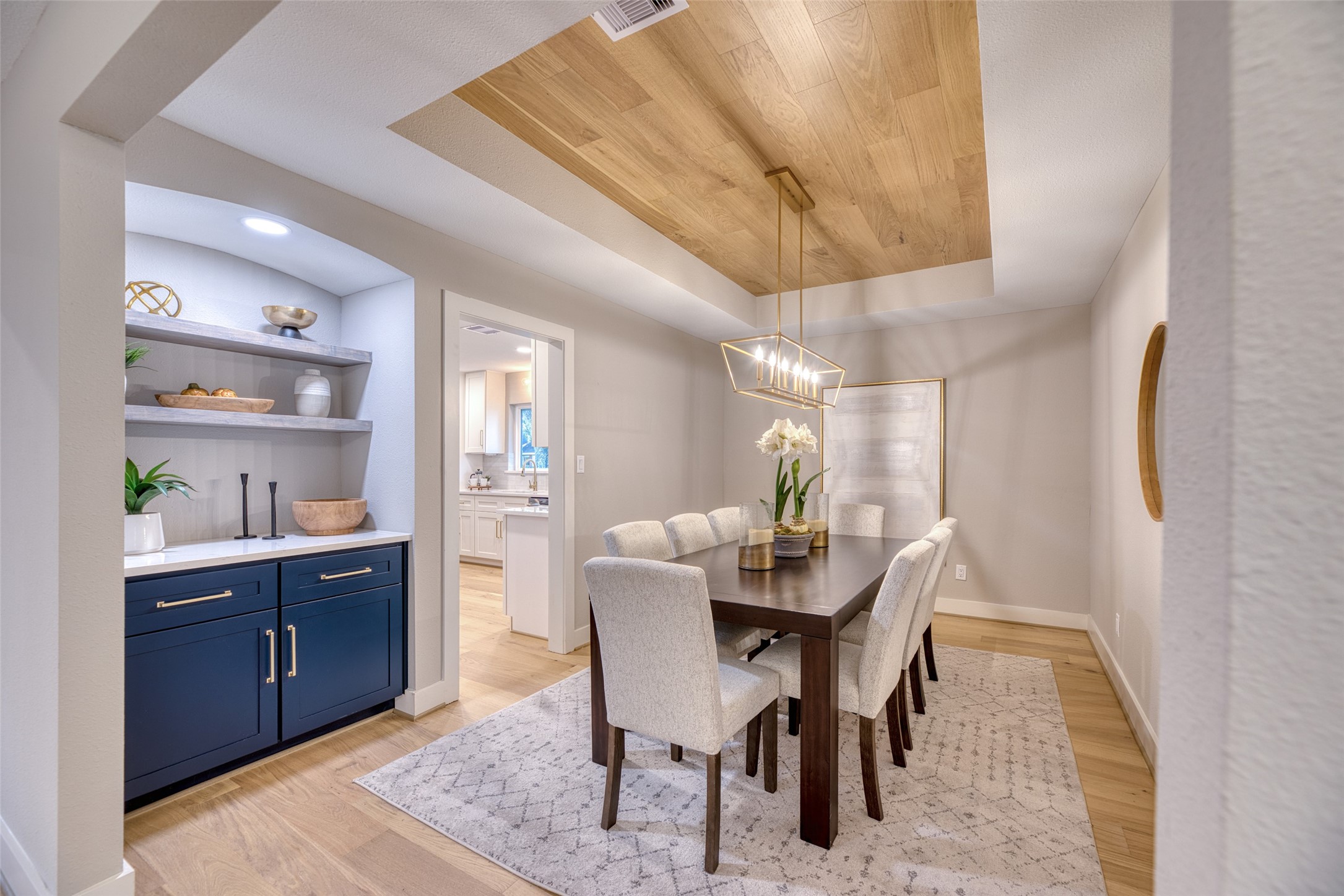 7602 Pagewood Lane Houston, TX 77063 - Photo 9 of 33 Dining area features a tray ceiling and elegant wood accents.