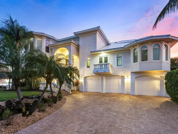 a front view of a house with a yard and a garage